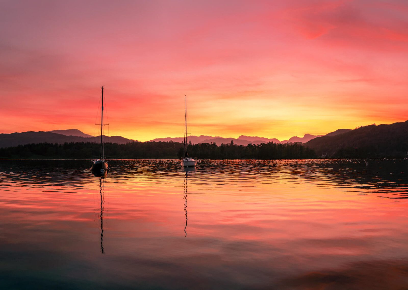 reflections of boats on windermere