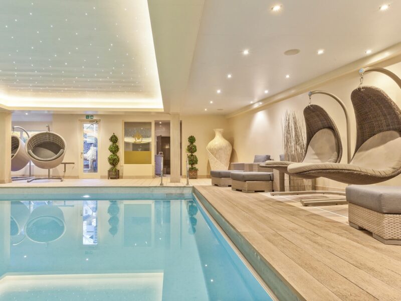indoor swimming pool with chairs and seating